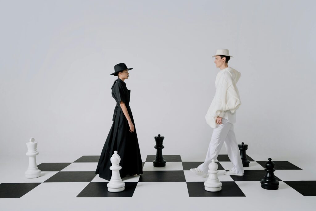 pexels-photo-8443644-8443644 Artistic portrayal of fashion on a chessboard with models embodying black and white pieces.